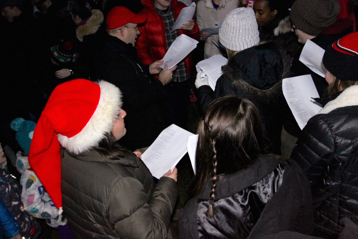 The Watertown High School Acapella group sang carols during the Tree Lighting Celebration in Watertown Square.
